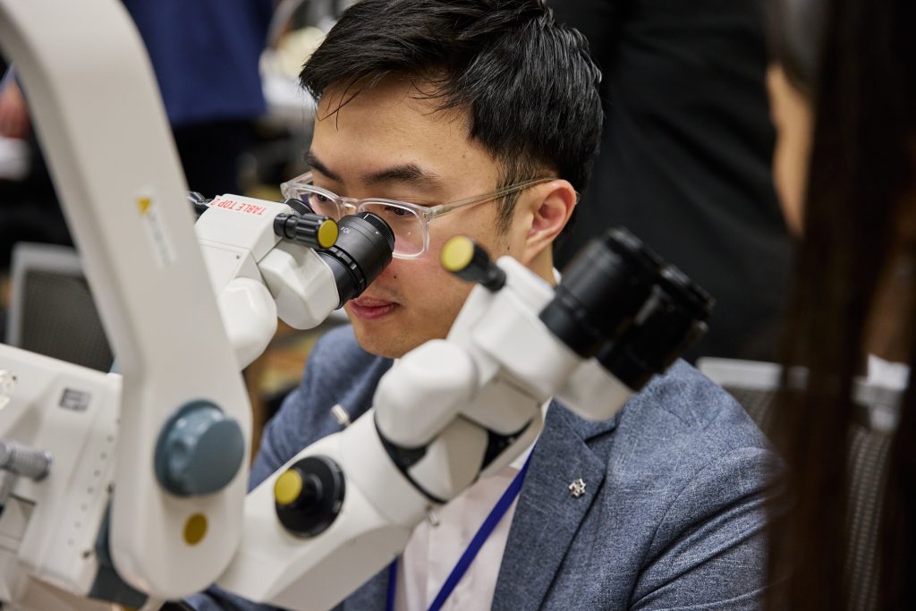 Ophthalmologist looking into instrument